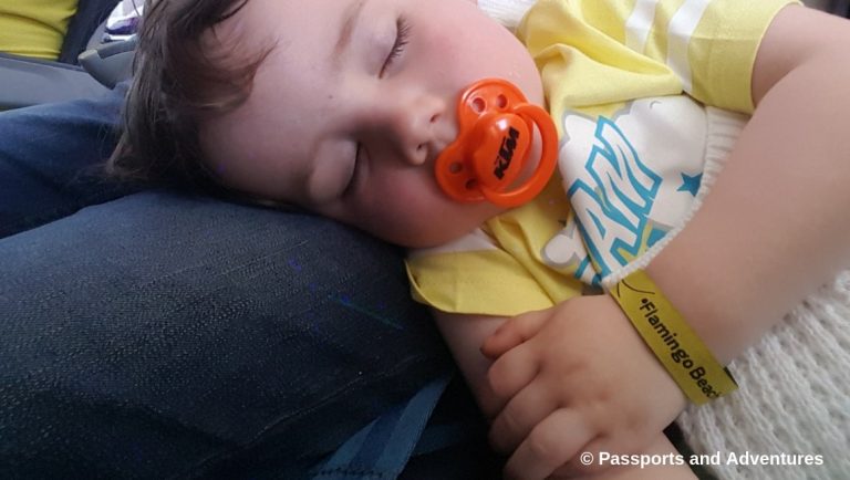 Awesome Tips For Flying With Babies and Toddlers - A toddler asleep on an airplane