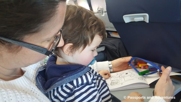 Awesome Tips For Flying With Babies and Toddlers - Mum and toddler colouring in with crayons on a plane