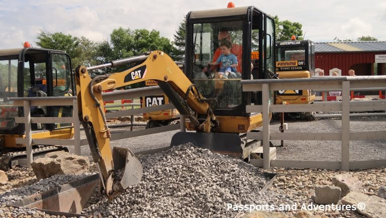 Dad and son on a CAT digger in Folly Farm.