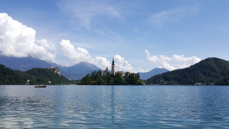 Lake Bled island with the church bell tower visible through the trees