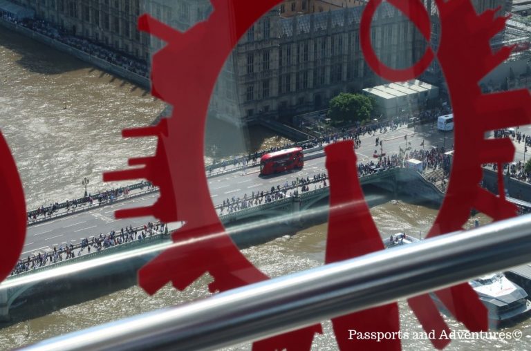 A view towards the House of Parliament from the London Eye with a double decker London bus crossing Westminster bridge