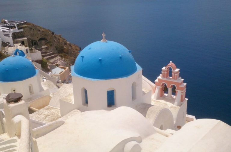 A picture of some of the blue roof tops of the Greek town of Santorini