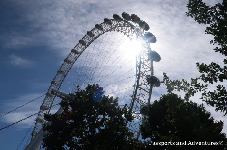 A upward view of the London Eye with the sun shining through the wheel