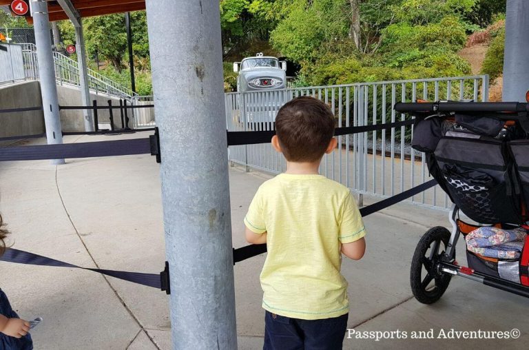 A little boy waiting at a gate for the Oregon Zoo train