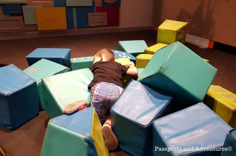 A little boy in a pile of soft play blocks in OMSI