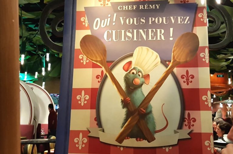 The sign inside Bistro Chez Remy featuring the chef mouse