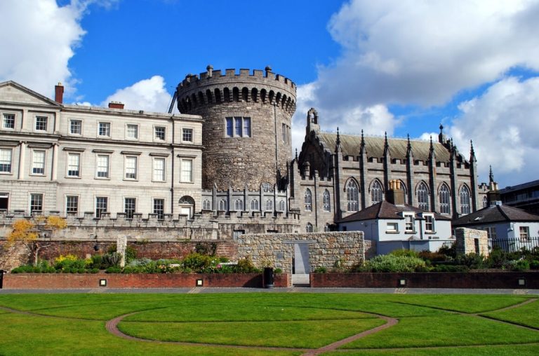 A picture of Dublin Castle with the green grass in the gardens in front