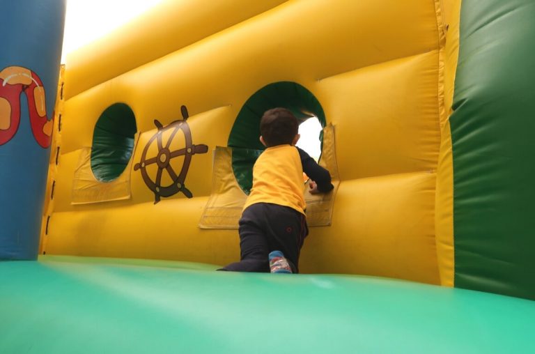 A picture of a young boy in an inflatable play area